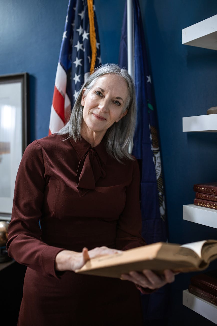 woman in brown long sleeve top holding an open book